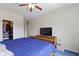 Bedroom with a bed, blue carpet, walk-in closet, and TV on a dresser at 8778 N Deer Crossing Blvd, McCordsville, IN 46055