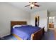 Bedroom with a wooden bed frame, blue carpet, and walk-in closet at 8778 N Deer Crossing Blvd, McCordsville, IN 46055