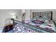 Bedroom with iron bed frame, a colorful quilt, and a side table with lamp at 8778 N Deer Crossing Blvd, McCordsville, IN 46055