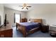 Bedroom with ceiling fan, a wooden bed frame, and a dresser at 8778 N Deer Crossing Blvd, McCordsville, IN 46055
