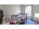 Bedroom featuring an iron bed frame, blue carpet, and patterned curtains at 8778 N Deer Crossing Blvd, McCordsville, IN 46055