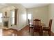 Cozy dining area with a fireplace and plenty of natural light from a window at 8778 N Deer Crossing Blvd, McCordsville, IN 46055