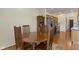 Well-lit dining area with a round wooden table connected to the kitchen with modern stainless steel appliances at 8778 N Deer Crossing Blvd, McCordsville, IN 46055