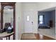 Inviting foyer featuring hardwood floors, a charming mirror, and access to living areas at 8778 N Deer Crossing Blvd, McCordsville, IN 46055
