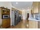A large kitchen with stainless steel appliances, wood cabinets, and granite countertops at 8778 N Deer Crossing Blvd, McCordsville, IN 46055