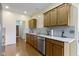 A kitchen with tiled backsplash, granite countertops and wood cabinets next to an entry way at 8778 N Deer Crossing Blvd, McCordsville, IN 46055