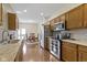 Bright kitchen featuring stainless steel appliances, wood cabinets, and an adjacent dining area at 8778 N Deer Crossing Blvd, McCordsville, IN 46055