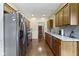A modern kitchen with stainless steel appliances and tiled backsplash with wood cabinets and granite countertops at 8778 N Deer Crossing Blvd, McCordsville, IN 46055