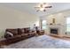 Comfortable living room with hardwood floors, a cozy fireplace, and large windows at 8778 N Deer Crossing Blvd, McCordsville, IN 46055