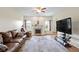 Inviting living room with hardwood floors, a fireplace, and a modern entertainment center at 8778 N Deer Crossing Blvd, McCordsville, IN 46055