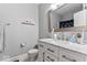 Stylish bathroom featuring a white vanity with marble countertop, modern fixtures, and a framed mirror at 914 N Alabama St, Indianapolis, IN 46202