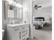Bathroom boasts a white vanity with marble counters, and it opens to a bedroom with a view of the bed at 914 N Alabama St, Indianapolis, IN 46202