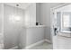 Bright hallway with stairs, modern light fixture and a glimpse of a home office at 914 N Alabama St, Indianapolis, IN 46202