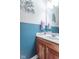 Half-bathroom featuring neutral walls, wooden vanity, modern fixtures, and a sleek, minimalist design at 1035 White Oak Dr, Plainfield, IN 46168