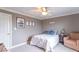 Well-lit bedroom showcasing neutral carpet, a ceiling fan, and a comfortable sitting chair at 1035 White Oak Dr, Plainfield, IN 46168