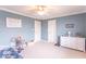 Neutral bedroom with white trim, features a ceiling fan, a white dresser, and neutral carpet at 1035 White Oak Dr, Plainfield, IN 46168