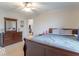 Inviting bedroom boasts a comfortable bed and a traditional wood dresser with natural lighting at 1035 White Oak Dr, Plainfield, IN 46168