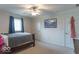 Relaxing bedroom with plush carpet, a ceiling fan, and a view of the window at 1035 White Oak Dr, Plainfield, IN 46168