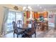 Charming dining area features wooden cabinetry, stainless steel appliances, and outdoor access for seamless living and dining at 1035 White Oak Dr, Plainfield, IN 46168