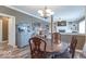 Elegant dining area with a chandelier, wooden table and decorative hutch, blending into the cozy living space at 1035 White Oak Dr, Plainfield, IN 46168