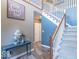 Inviting foyer with staircase, stylish decor, and warm, neutral color palette creating a welcoming ambiance at 1035 White Oak Dr, Plainfield, IN 46168