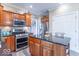 Modern kitchen featuring stainless steel appliances, granite countertops, and cherry wood cabinets at 1035 White Oak Dr, Plainfield, IN 46168