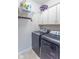 Functional laundry room with washer, dryer, storage cabinets, and practical shelving for efficient organization at 1035 White Oak Dr, Plainfield, IN 46168