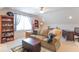 Cozy bonus living room with natural light, bookshelves, and comfortable seating at 1035 White Oak Dr, Plainfield, IN 46168