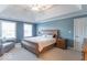 Comfortable main bedroom with natural light, soft carpet, and soothing blue walls, perfect for relaxation and rest at 1035 White Oak Dr, Plainfield, IN 46168