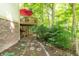 Secluded backyard featuring a patio, lush landscaping, and a pathway leading through the garden at 10518 Courageous Dr, Indianapolis, IN 46236