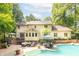 Spacious backyard with a large deck, inground pool, and patio seating area for entertaining at 10518 Courageous Dr, Indianapolis, IN 46236