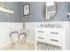 A well-appointed bathroom featuring a white vanity, wainscoting, and an oval mirror at 10518 Courageous Dr, Indianapolis, IN 46236