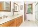 Bright bathroom featuring double sinks, wooden cabinets, and a window with natural light at 10518 Courageous Dr, Indianapolis, IN 46236