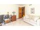 A well-lit room with comfortable seating, wood accents, and a view into the hallway at 10518 Courageous Dr, Indianapolis, IN 46236