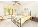 Comfortable bedroom with large window, carpet floors, and ceiling fan at 10518 Courageous Dr, Indianapolis, IN 46236