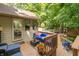 Outdoor wooden deck with comfortable seating, a grill, and access to the home's interior at 10518 Courageous Dr, Indianapolis, IN 46236