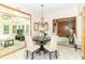 Dining room with chandelier adjacent to a sunroom features neutral decor and bright natural light at 10518 Courageous Dr, Indianapolis, IN 46236
