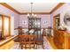 Formal dining room with wood table, decorative chandelier, and elegant decor at 10518 Courageous Dr, Indianapolis, IN 46236