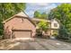 Beautiful brick and siding home with an attached two-car garage and a manicured front yard at 10518 Courageous Dr, Indianapolis, IN 46236