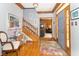 Elegant home foyer with hardwood floors, a staircase, and stylish decor at 10518 Courageous Dr, Indianapolis, IN 46236