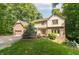 Charming two-story home with brick accents, a well-manicured lawn, and mature trees at 10518 Courageous Dr, Indianapolis, IN 46236