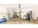 Spacious garage with ample storage, a refrigerator, and access to an exterior door at 10518 Courageous Dr, Indianapolis, IN 46236