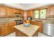 Well-lit kitchen features stainless steel appliances, granite countertops, and wood cabinets at 10518 Courageous Dr, Indianapolis, IN 46236