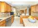 Kitchen with custom cabinets and stainless steel appliances is open to the dining area at 10518 Courageous Dr, Indianapolis, IN 46236