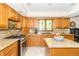 Kitchen features custom cabinets, granite countertops, stainless steel appliances, and natural light at 10518 Courageous Dr, Indianapolis, IN 46236