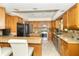 Well-lit kitchen features custom cabinets, stainless steel appliances, granite countertops, and an island at 10518 Courageous Dr, Indianapolis, IN 46236