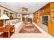Cozy living room with wood trim, built-in shelving, fireplace, plush seating, and sliding glass doors at 10518 Courageous Dr, Indianapolis, IN 46236