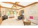 Living room with beamed ceiling featuring multiple seating areas, a piano, and natural light at 10518 Courageous Dr, Indianapolis, IN 46236