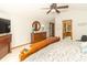 Bedroom with wooden furniture, including a dresser with round mirror, and a view into the en-suite bathroom at 10518 Courageous Dr, Indianapolis, IN 46236