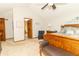 Another view of a spacious main bedroom with carpet flooring and a door to the bathroom at 10518 Courageous Dr, Indianapolis, IN 46236